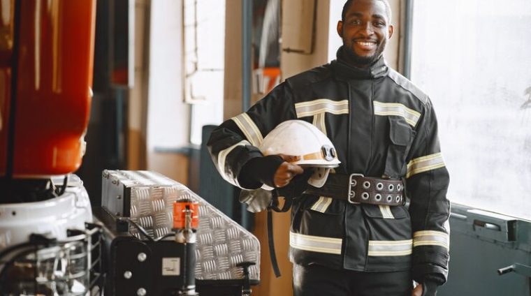 portrait-firefighter-standing-front-fire-engine_1157-46922