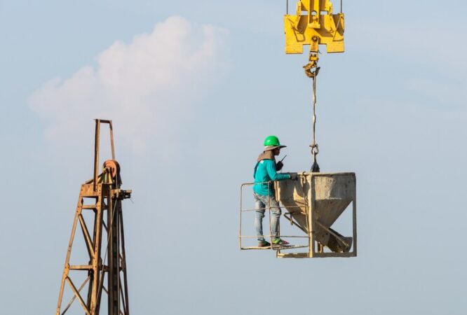 workers-work-crane-construction-site_1150-15379