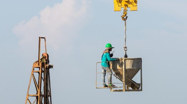 workers-work-crane-construction-site_1150-15379