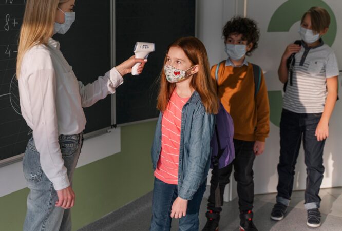 female-teacher-with-medical-mask-checking-children-s-temperature-school_23-2148848279