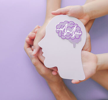 Adult and child hands holding encephalography brain paper cutout,autism, Stroke, Epilepsy and alzheimer awareness, seizure disorder, stroke, ADHD, world mental health day concept