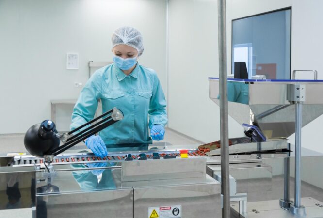 pharmacy-industry-woman-worker-protective-clothing-operating-production-tablets-sterile-working-conditions_645730-398