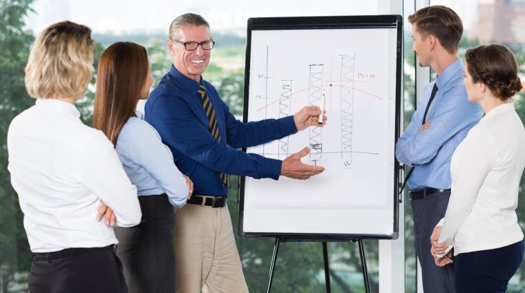 smiling-speaker-explaining-bar-chart-audience_1262-2003